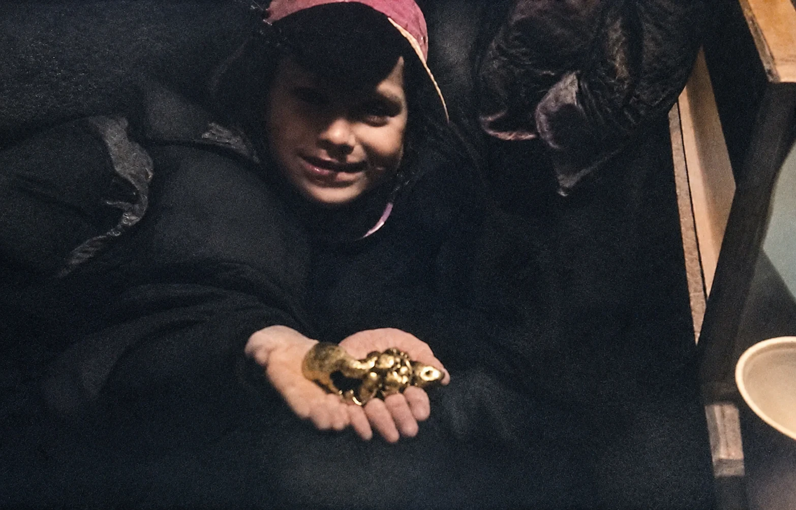 Thomas as a child holding a large gold nugget