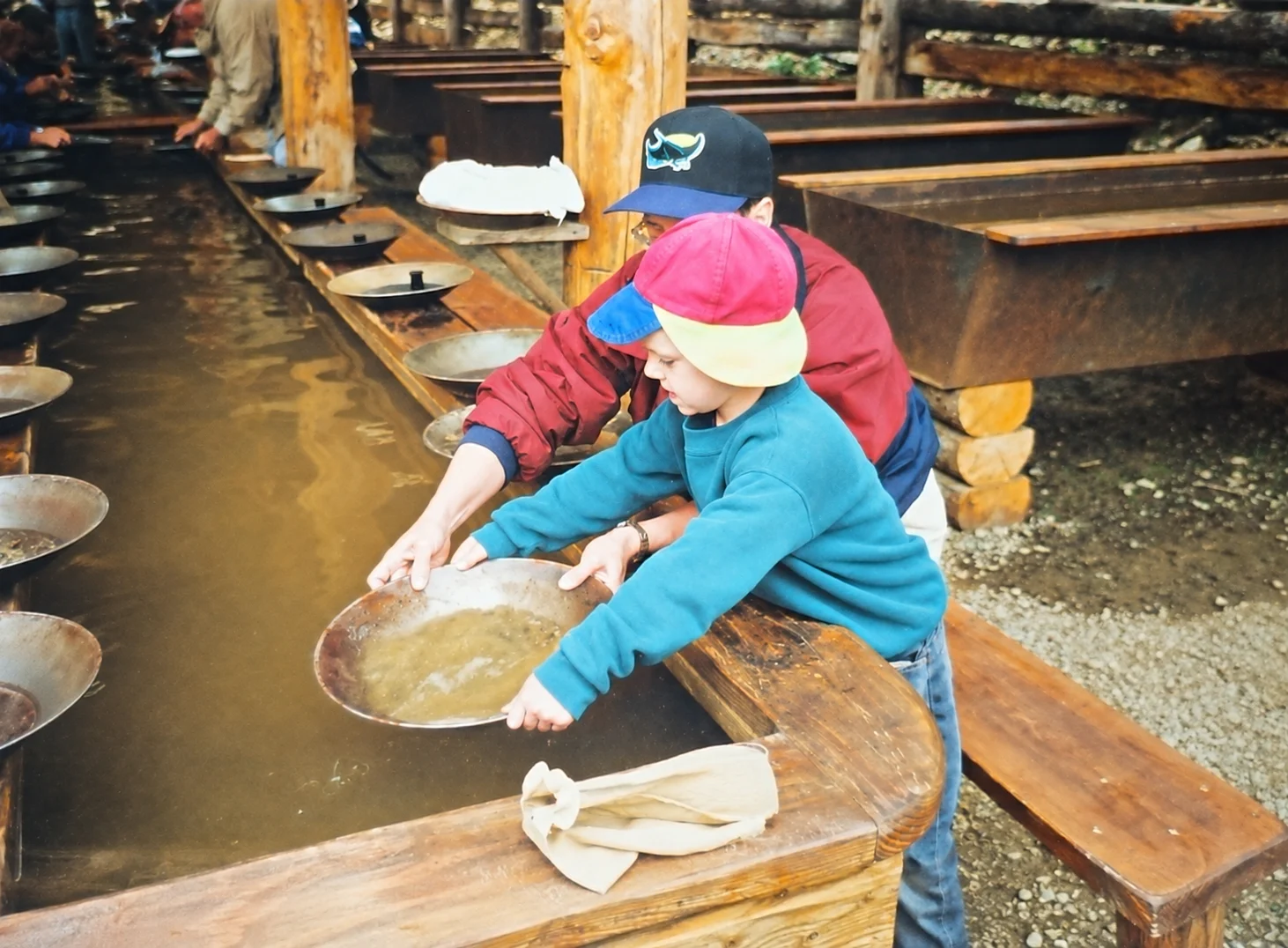 Thomas as a child panning for gold with one of his aunts